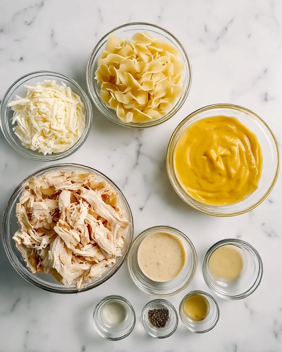 The image shows seven small glass bowls on a white marbled surface, each containing different ingredients for a recipe. In the top left bowl, there is shredded white cheese, looking soft and crumbly. To the right, a small bowl holds a thick, bright yellow sauce, smooth and creamy. Below this, another bowl contains a light beige sauce with small bits, creamy and thick. In the center, a larger bowl is full of uncooked wide egg noodles, pale yellow with a ruffled texture. Bottom left has a bowl with shredded cooked chicken, light tan in color, fibrous and tender looking. In front of these bowls, there are three tiny glass bowls holding clear liquids and black pepper, arranged in a neat row. The background is a clean white marble, giving a fresh and neat look. photo taken with an iphone --ar 4:5 --v 7