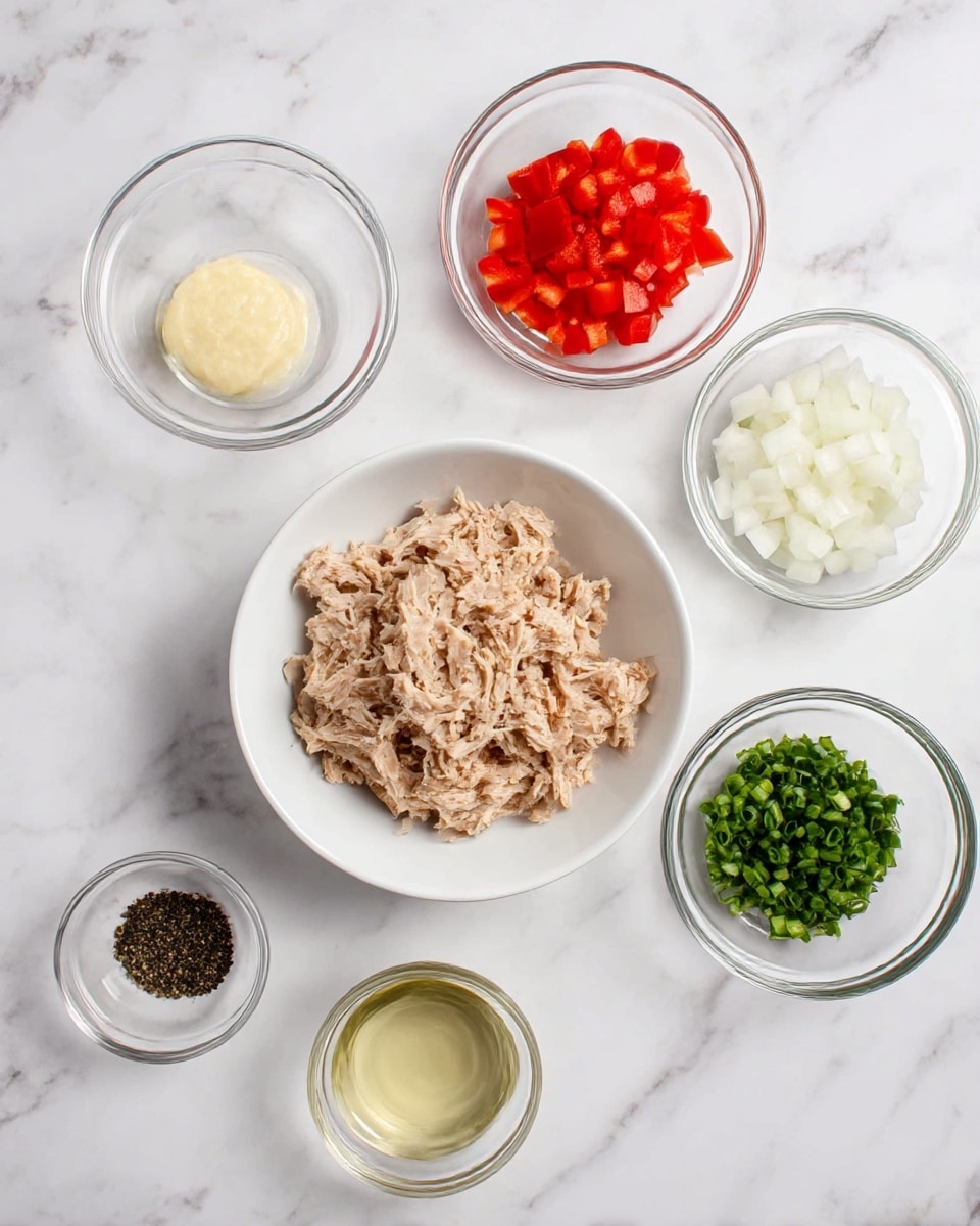 The image shows six small glass bowls arranged on a white marbled surface. In the center is a white bowl filled with shredded, light brown tuna. Surrounding it are five smaller glass bowls: one with finely chopped red bell peppers at the top, one with small chunks of white onion to the right, one with green chopped herbs at the bottom right, one with a pale yellow creamy substance to the top left, one with clear liquid at the bottom center, and one with black pepper at the bottom left. The layout is neat, and the colors of the ingredients stand out clearly against the white marbled background. photo taken with an iphone --ar 4:5 --v 7