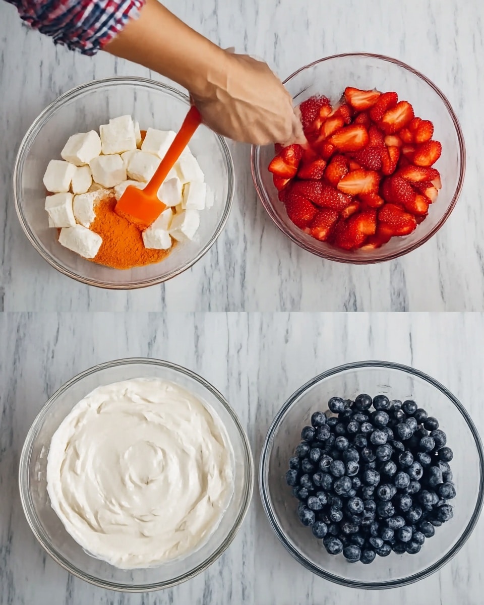 The image shows four clear glass bowls on a white marbled surface. The first bowl has white square pieces layered with orange powder and a woman’s hand holding an orange spatula stirring the mixture. The second bowl is filled to the top with a smooth, white creamy layer. The third bowl contains many shelled strawberry halves, bright red in color, spread evenly to cover the surface. The fourth bowl is filled with a neat layer of dark blue blueberries arranged closely together. photo taken with an iphone --ar 4:5 --v 7