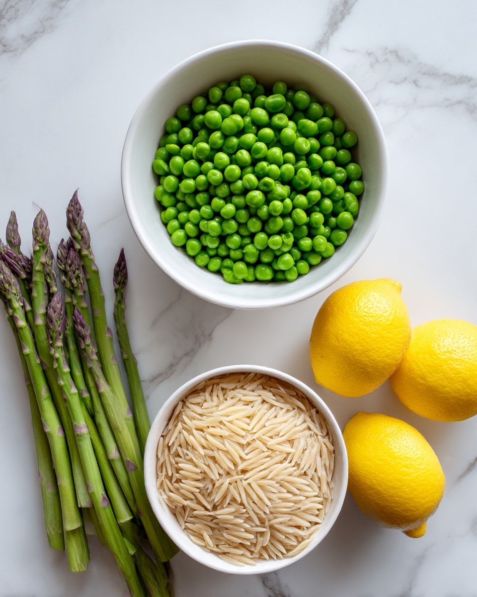 The image shows two small white bowls placed on a white marbled surface. The top bowl is filled with bright green peas, and the bottom bowl contains uncooked orzo pasta with a light beige color. To the left of the bowls, there is a small bunch of fresh asparagus stalks with a green color and purple tips. On the right side of the bowls, three bright yellow lemons are grouped together. The overall setup is simple and clean with a bright, natural light. photo taken with an iphone --ar 4:5 --v 7