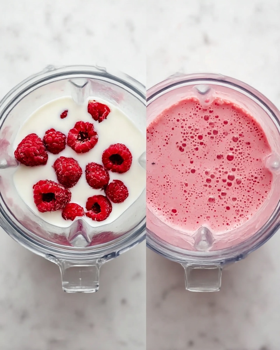 The image shows two clear blender containers on a white marbled surface. The left container has one layer of white milk with a group of red raspberries floating on top, some whole and some sliced. The right container shows the blended result, where the raspberries and milk turned into a smooth, frothy pink mixture with small bubbles on the surface. Both containers are seen from above, showing the texture inside clearly. photo taken with an iphone --ar 4:5 --v 7