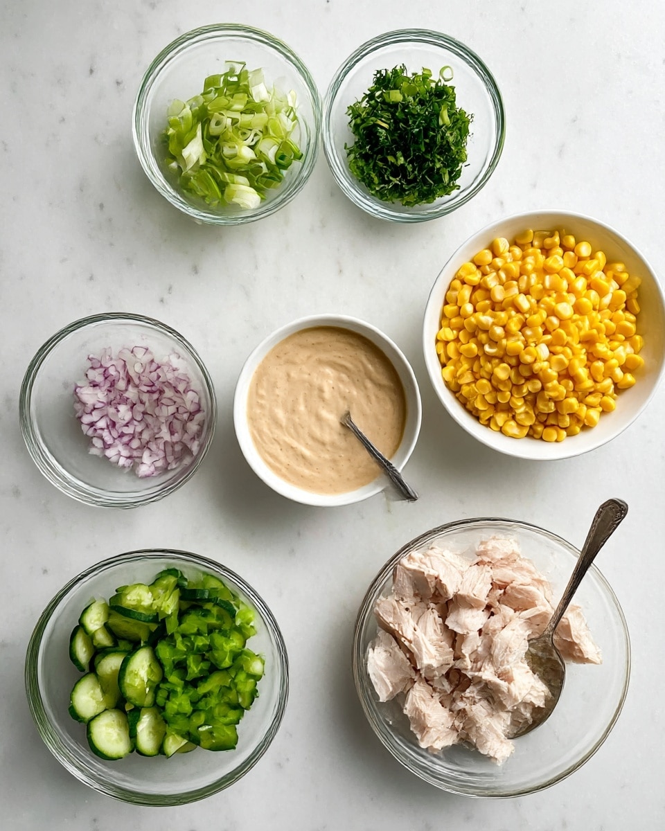 The image shows seven small bowls on a white marbled surface, each with different ingredients. Starting from the top left, there is a small clear glass bowl filled with sliced green onions, and to the right, a similar bowl holds chopped green herbs. Below them on the right, a white bowl contains bright yellow corn kernels. Below the corn, another small clear glass bowl has chopped green peppers. To the left of that, a clear glass bowl is filled with sliced cucumber pieces. Underneath, there is a small clear glass bowl with finely chopped red onions. On the left side near the middle, a white bowl holds pale cooked chicken pieces, and nearby, a larger white bowl contains a light brown creamy sauce with a spoon inside. The bowls are arranged neatly, showing a fresh and colorful mix of ingredients. photo taken with an iphone --ar 4:5 --v 7