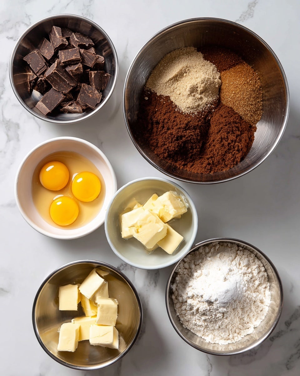 The image shows six metal and white bowls placed on a white marbled surface. The largest metal bowl in the center holds a mix of dark brown sugar with visible granules, vanilla, and kosher salt, showing a small uneven mound in the bowl. To the left, a smaller metal bowl contains dark chocolate chunks and a layer of brown cocoa powder, side by side. At the bottom left, a small white bowl holds four cracked eggs and egg yolks, their bright yellow color contrasting with the white bowl. To the bottom right, a medium metal bowl has cubed room temperature butter in pale yellow tones. Finally, to the right, a medium metal bowl contains white flour mixed with baking soda, with a small mound of baking soda visible on top. The bowls are arranged neatly, creating a balanced and organized look. Photo taken with an iphone --ar 4:5 --v 7