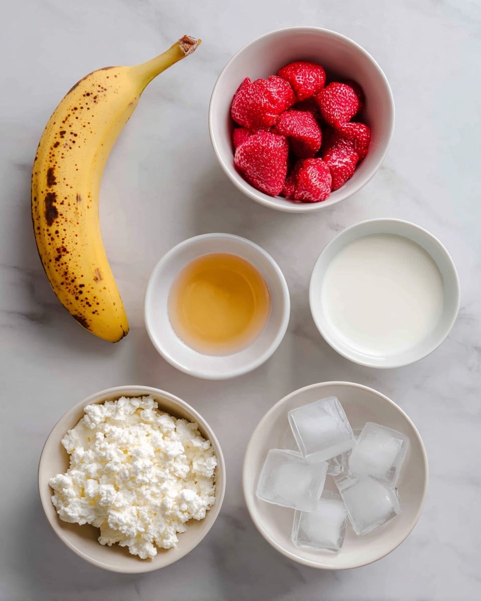 The image shows six ingredients placed on a white marbled surface, each in its own white bowl or visible as a single item. In the top left is half a yellow banana with brown spots. To the right, there is a white bowl filled with bright red frozen strawberries. Below the banana is a small white bowl with light golden honey, labeled optional. In the center, there is a small white bowl filled with white, lumpy cottage cheese. Below the cottage cheese is another small white bowl containing white milk. To the right of the milk, a white bowl holds several clear ice cubes. The setup is neat and simple, highlighting each ingredient separately. Photo taken with an iphone --ar 4:5 --v 7