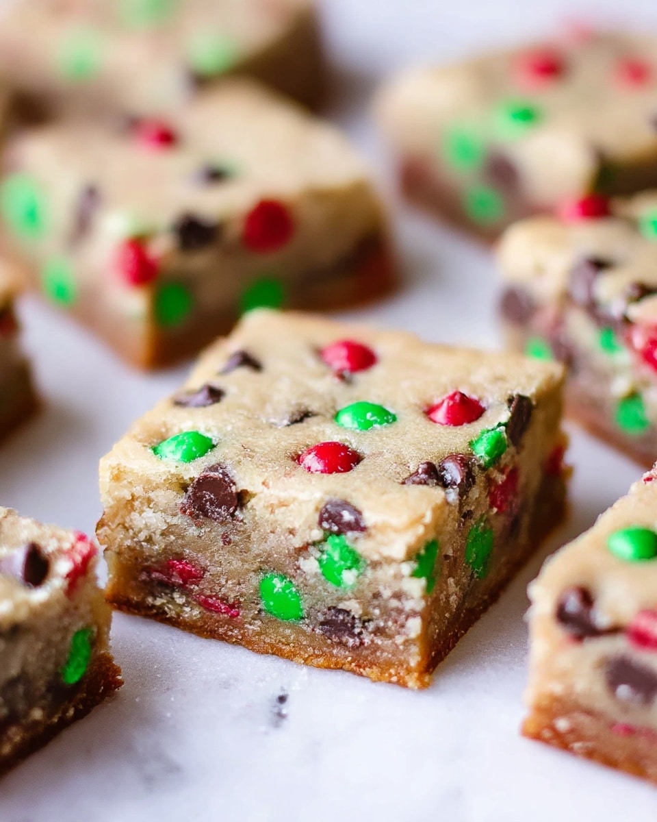 A clear bowl shows light tan dough being mixed with a white mixer paddle in the first layer. The second layer features the same light tan dough in a white bowl, covered with red, green, and dark brown candy-coated chocolates, being stirred with a wooden spoon. The third layer shows the candy-studded dough spread out evenly on foil in a white pan, with red, green, and dark brown candies visible across the surface. The fourth layer highlights close-up sliced bars of the baked dough, showing a light golden texture with embedded colorful red, green, and dark brown candies inside, all resting on foil over a white marbled surface. Photo taken with an iphone --ar 4:5 --v 7
