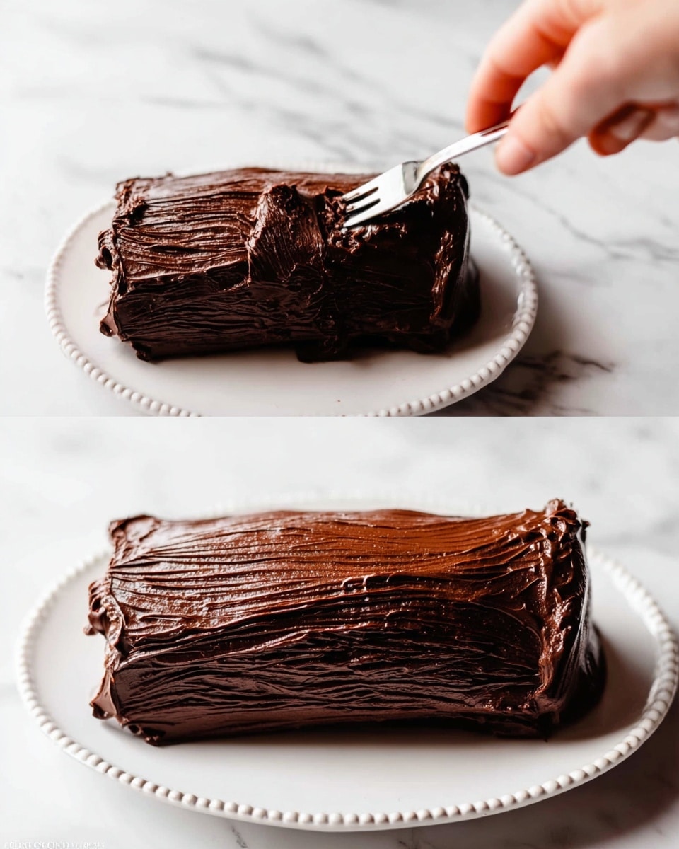 A small chocolate cake log is placed on a white plate with a simple beaded border design. The cake has a thick, dark brown chocolate frosting covering it completely, with visible textured lines resembling tree bark made by dragging a fork over the top. On the left side, a woman's hand holding a silver fork is gently pressing into the top layer of the chocolate frosting, showing its smooth yet slightly rippled texture. The background surface is a white marbled texture, adding a clean and bright look to the scene. photo taken with an iphone --ar 4:5 --v 7