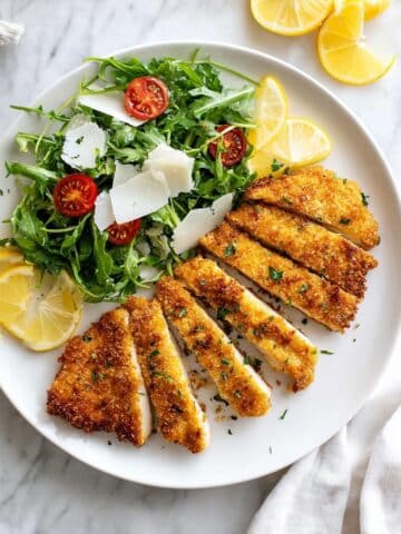 Crispy Chicken Milanese with Arugula, Tomatoes, and Shaved Parmesan Recipe
