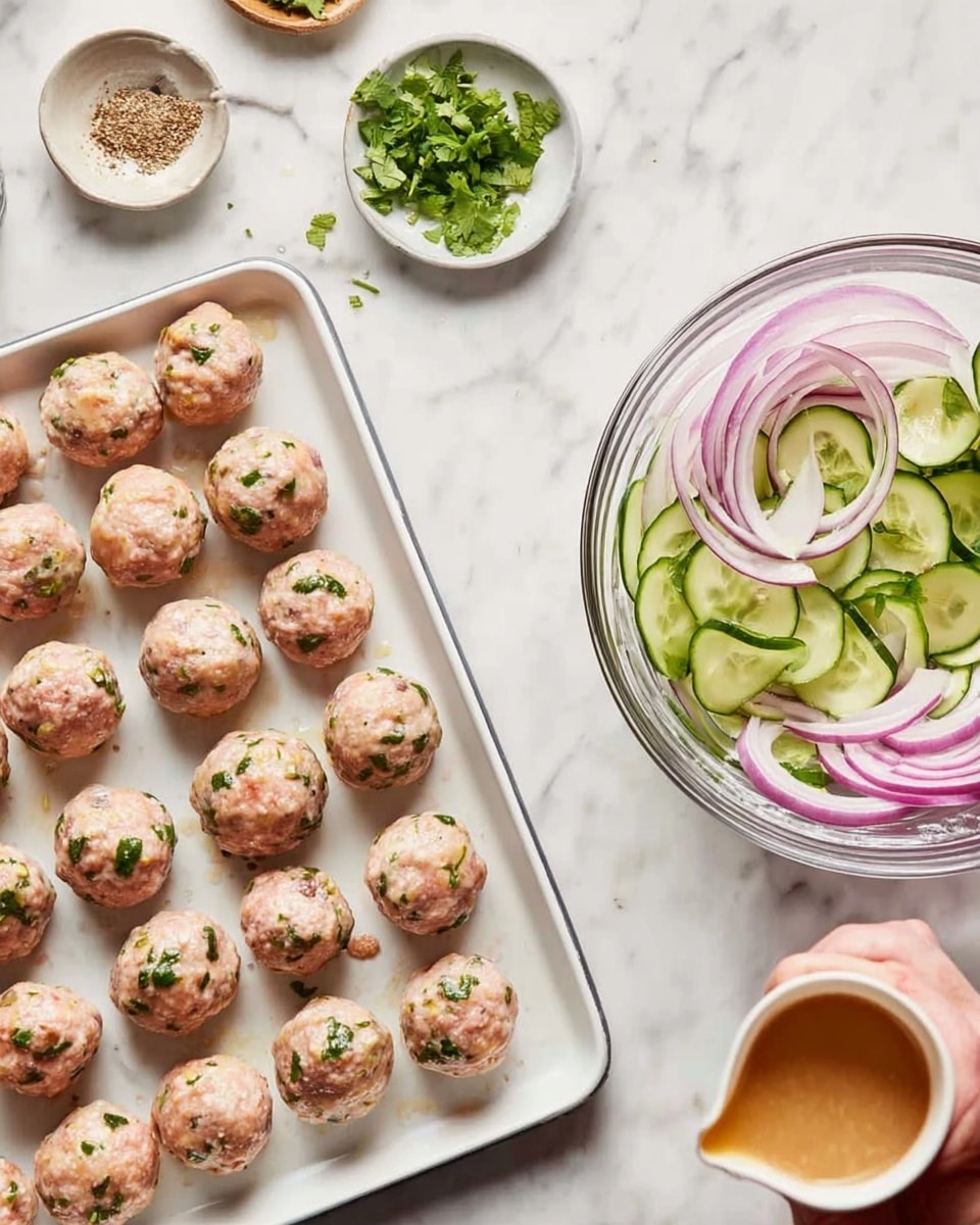The image shows two parts: on the left, a white rectangular tray filled with 20 round raw meatballs, each light pink with green herbs mixed in, placed on a white marbled surface with small dishes of seasoning and cilantro sprigs nearby. On the right, a clear glass bowl on the same white marbled surface holds thin round cucumber slices and rings of purple onion, with a woman's hand holding a small white cup pouring a light tan liquid over the vegetables. Photo taken with an iphone --ar 4:5 --v 7