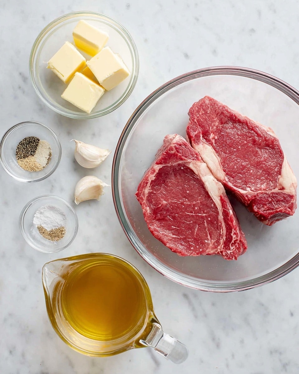 Two raw red beef steaks with white fat edges sit in a clear round glass bowl on a white marbled surface. Above the bowl, a small clear glass bowl contains two pale yellow squares of butter. To the right, a small clear glass bowl holds three piles of seasonings in white, black, and light brown. Two whole garlic cloves lay nearby. A small clear glass bottle of light golden olive oil stands by a clear glass measuring cup filled with light brown broth. The scene is well lit and arranged neatly. photo taken with an iphone --ar 4:5 --v 7