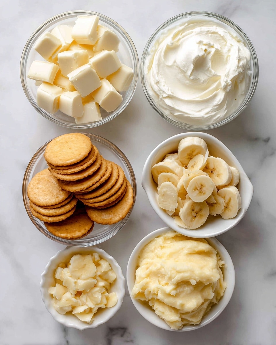 The image shows five small clear glass bowls on a white marbled surface, each filled with different ingredients. The top left bowl contains creamy white chunks of white chocolate. To the right, a bowl filled with smooth, thick, white cream cheese. Below the white chocolate, there is a white bowl with round, golden vanilla wafers stacked standing upright. Next to the cream cheese, a small bowl holds light yellow banana chips. At the bottom center, another bowl contains soft, pale yellow ripe mashed banana with a slightly chunky texture. photo taken with an iphone --ar 4:5 --v 7