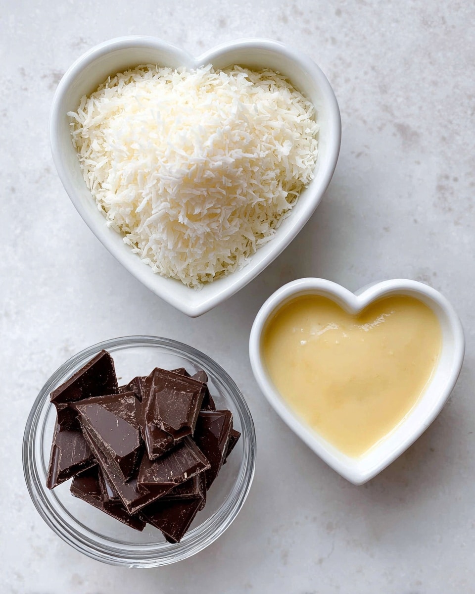 The image shows three small containers arranged on a white marbled surface. At the top, a white heart-shaped bowl is filled to the brim with finely shredded white coconut, showing a soft and fluffy texture. Below to the right, another white heart-shaped bowl contains a smooth, pale yellow condensed milk filling, with a glossy surface. To the left of this, a round clear glass bowl holds dark chocolate pieces that are flat and irregularly shaped with a rich, deep brown color. Each container distinctly shows its ingredient in simple, clear layers. Photo taken with an iphone --ar 4:5 --v 7