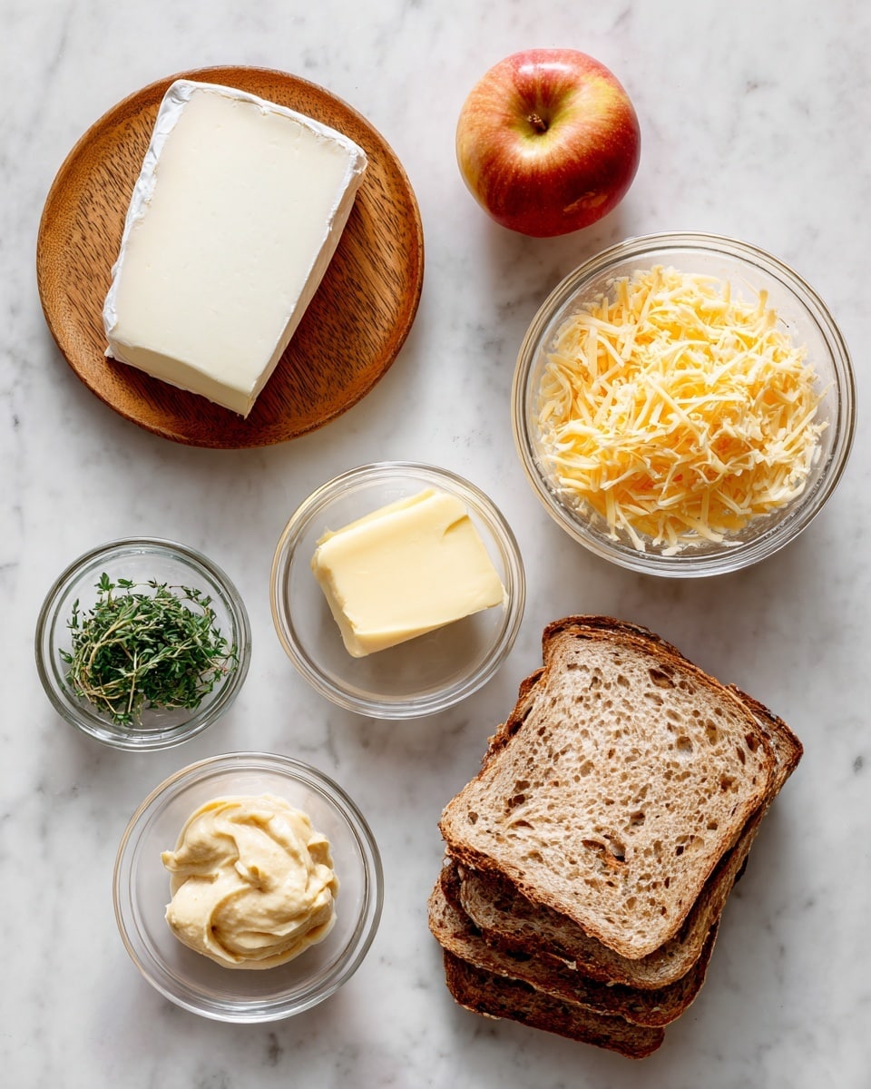 The image shows ingredients for a sandwich arranged on a white marbled surface. At the bottom, there are four slices of brown bread stacked slightly over each other with a rough texture and crusty edges. Above the bread, to the left, is a round wooden plate with a large wedge of white brie cheese, smooth and soft in texture. To the right of the brie, there is a silver measuring cup filled with finely grated pale yellow cheddar cheese, almost overflowing. Above the cheddar is a small clear glass bowl holding pale yellow butter. To the left of the butter, close to the center, is another small clear glass bowl filled with creamy, grainy mustard that is light brown in color. Above the mustard and a bit to the left is another small clear glass bowl containing fresh green herbs. At the top center of the image rests a single bright red and yellow apple. The ingredients are spread out neatly with bright, natural lighting. Photo taken with an iphone --ar 4:5 --v 7