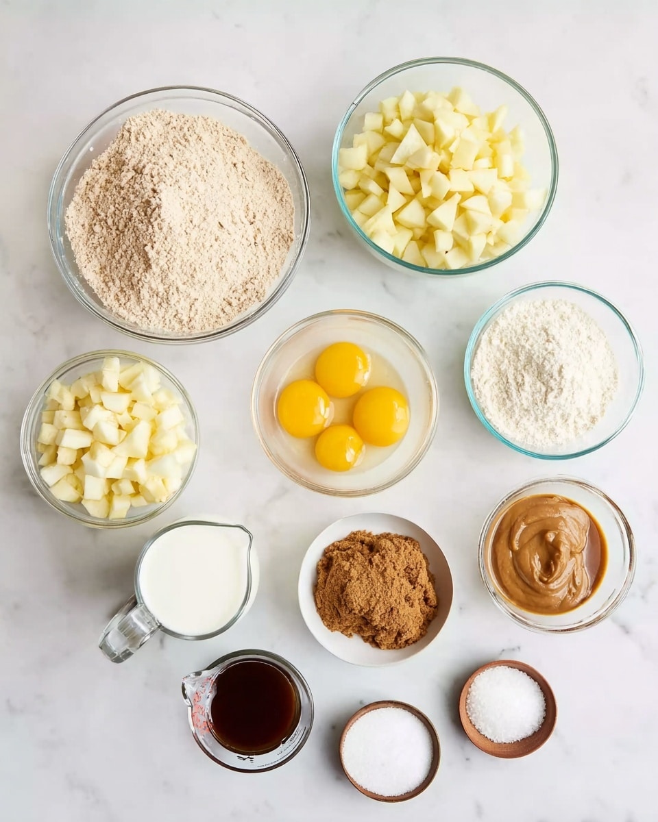 Several clear glass bowls and a measuring cup are placed on a white marbled surface, each holding different ingredients. One large bowl contains light brown flour, another medium bowl has chopped pale yellow apple pieces, and a third medium bowl holds a white creamy substance. Two raw eggs with bright yellow yolks sit in a separate medium bowl. A small bowl holds brown sugar, another has a thick brownish-yellow sauce or puree, and another one has a dark brown liquid, likely vanilla extract. There are also three very small bowls with white powders and granules, likely baking soda, baking powder, and salt. A clear measuring cup contains a small amount of white milk. Photo taken with an iphone --ar 4:5 --v 7