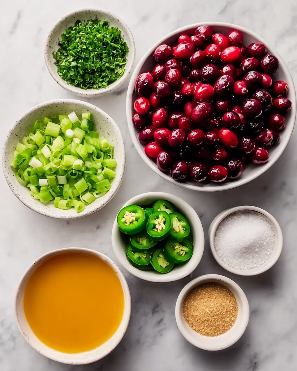 The image shows seven white small bowls arranged on a white marbled surface. The largest bowl at the top right is filled with shiny red cranberries. Below and around it, the other bowls hold different ingredients: one has bright green chopped herbs, another has light green sliced green onions, one contains light brown granulated sugar, another has deep green sliced jalapeño rings with visible seeds, one holds a smooth orange liquid, and the last bowl contains fine white salt. The bowls are displayed neatly, showing vibrant colors of the fresh ingredients. Photo taken with an iphone --ar 4:5 --v 7