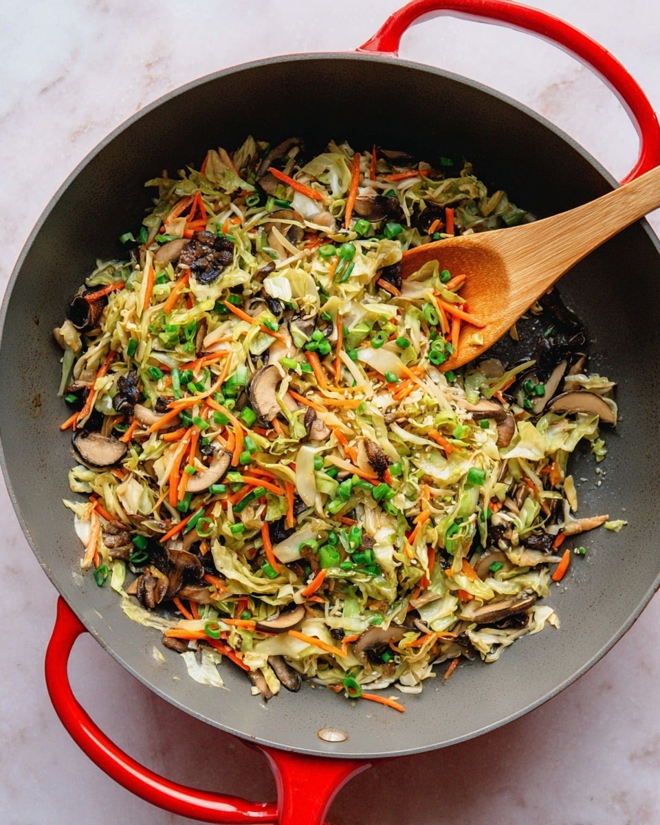 In a large dark gray pan with red handles, there is a stir fry made of different veggies. The stir fry has three main layers: chopped green onions scattered all over, small pieces of dark brown mushrooms, and thin shredded strips of orange carrots and pale green cabbage mixed throughout. A wooden spoon is inside the pan, partly covered by the vegetables. The pan is placed on a white marbled surface. photo taken with an iphone --ar 4:5 --v 7