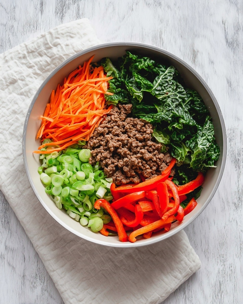 A white pan sits on a white marbled texture with a light cream cloth underneath. Inside the pan, five ingredients are arranged side by side without mixing. On the left is a pile of thin orange carrot strips, next to it are bright green round slices of spring onions. To the right of the spring onions is a heap of cooked ground meat with a soft brown color. Above the meat is a layer of dark green, crinkly cabbage leaves, and next to the cabbage are long red bell pepper strips with a shiny texture. The ingredients show clear texture differences and colors set in distinct sections. photo taken with an iphone --ar 4:5 --v 7