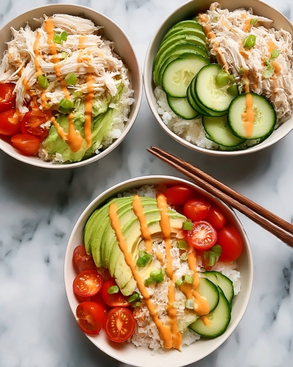Three bowls hold a rice base as the first layer, topped with shredded white chicken on one side. Next to the chicken, there are slices of bright green avocado curved neatly. On another side, several thin, round slices of green cucumber are placed. Halved cherry tomatoes with a shiny red color form another section. The bowls are finished with a drizzle of orange sauce across the top and small green onion pieces sprinkled near the tomatoes. Two wooden chopsticks rest on one bowl. All bowls are white, placed on a white marbled surface. Photo taken with an iphone --ar 4:5 --v 7