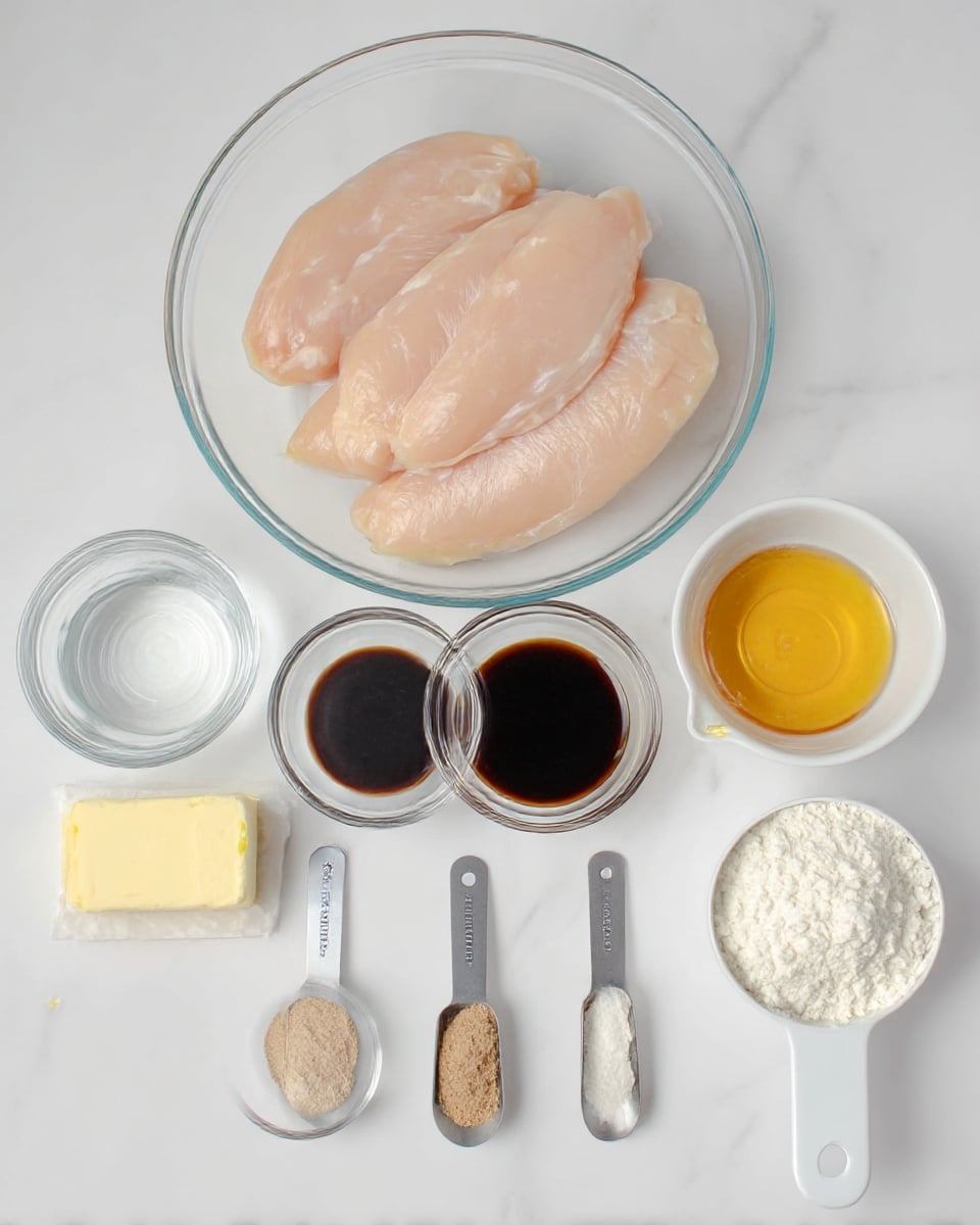 A clear glass bowl on a white marbled surface holds four raw, pale pink chicken strips, arranged side by side. In front of the bowl, there are eight items lined up horizontally: a small clear bowl of water on the left, next to a small block of butter wrapped in paper, followed by a small clear bowl filled with dark soy sauce, a small clear bowl with golden honey, and a white measuring cup filled with flour on the far right. Below these, two small metal measuring spoons contain light brown powdered spices and a light grey powder, and a white measuring cup holds white cornstarch powder. All items are neatly spaced, photographed from above in soft natural light. Photo taken with an iphone --ar 4:5 --v 7