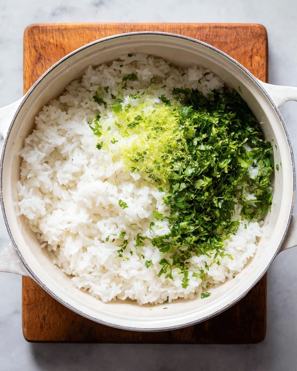 A white round pot filled with cooked white rice as the base layer, topped with bright green chopped cilantro on the right side and finely grated lime zest on the left side. The rice grains look soft and fluffy, with the green herbs adding a fresh contrast on top. The pot sits on a wooden square board, all placed on a white marbled surface. Photo taken with an iphone --ar 4:5 --v 7