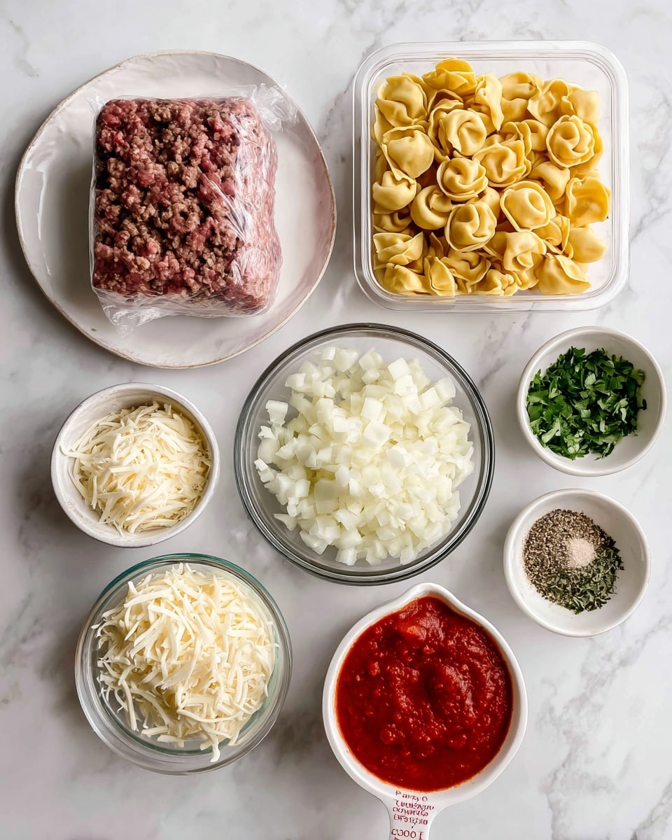 The image shows various cooking ingredients on a white marbled surface arranged neatly. At the top left is a white plate holding a block of ground beef wrapped in plastic. To its right is an opened plastic container filled with yellow tortellini pasta. Below the beef plate is a small glass bowl with shredded Parmesan cheese beside a larger white bowl filled with shredded mozzarella cheese. Next, a glass bowl with chopped white onions is placed beside fresh green herbs for garnish. A small white bowl with a mixture of garlic and Italian seasoning is near the bottom right corner. Finally, at the bottom center, there is a ceramic measuring cup with red marinara sauce inside. Photo taken with an iphone --ar 4:5 --v 7