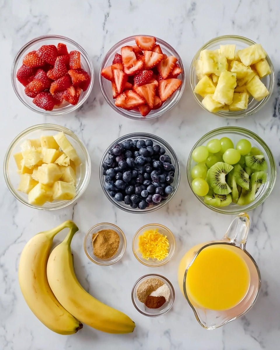 The image shows a white marbled surface with several clear glass bowls and small containers arranged neatly. There are four small bowls on top filled with bright red sliced strawberries, yellow orange slices, light green grapes, and dark blue blueberries from left to right. Below these, there are two clear bowls containing three whole bananas on the left and cubed yellow pineapple pieces next to them. To the right of the pineapple, a bowl holds green sliced kiwi fruit. In front of these larger bowls, there are four small clear containers holding orange zest, yellow zest, dark vanilla extract, and light brown sugar from left to right. On the far right, there is a clear glass measuring cup filled with orange juice and another with light yellow juice. The whole setup is clean and bright, with colors vivid against the white marble background. photo taken with an iphone --ar 4:5 --v 7