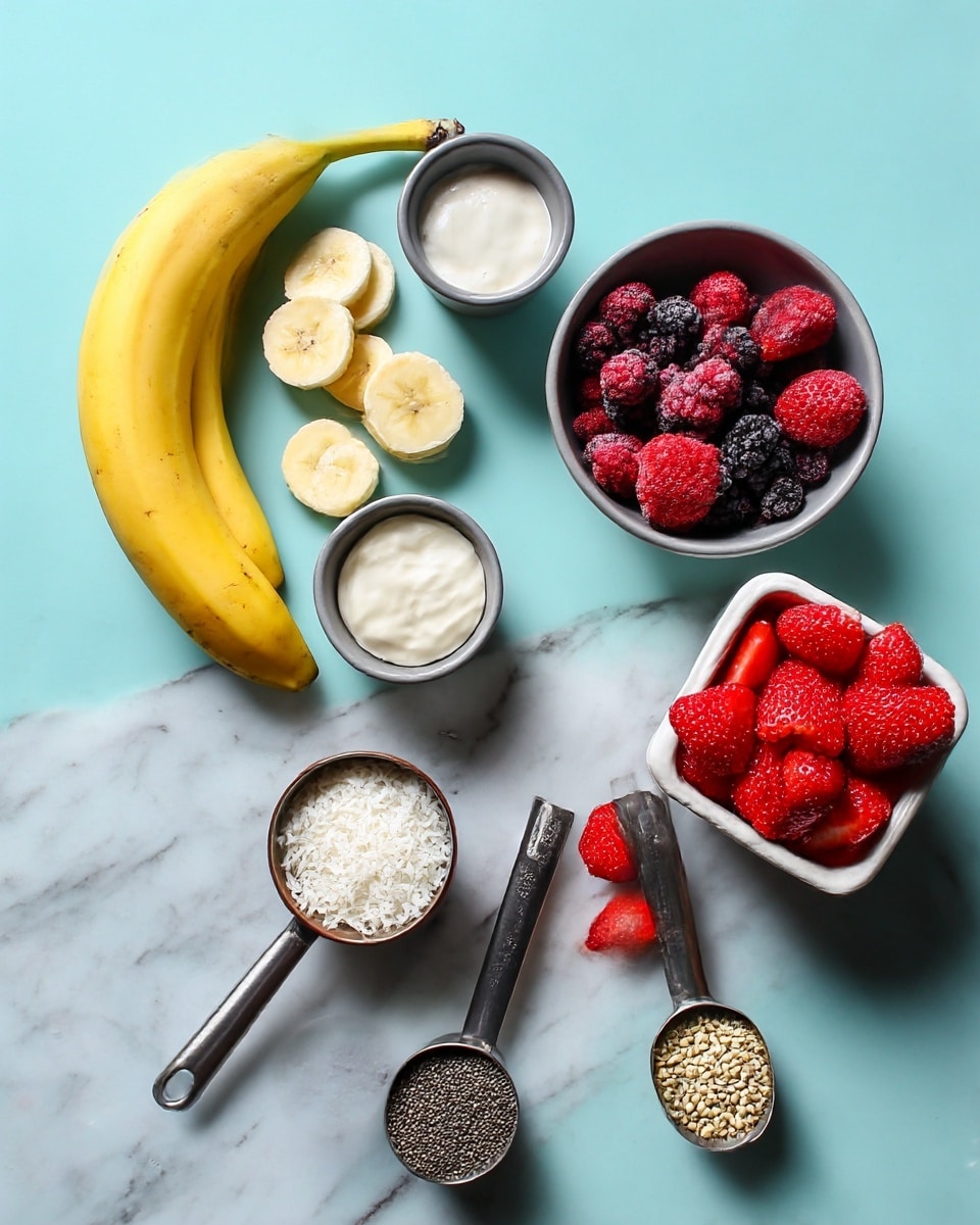 The image shows ingredients on a white marbled surface arranged neatly. There are two whole yellow bananas on the left. Above them, a small gray bowl holds round slices of banana. Next to it, a small gray cup contains white cream or yogurt. Above that, another gray bowl is filled with frozen mixed berries in shades of dark purple and red. On the right side is a white container overflowing with fresh red strawberries, with some strawberry slices scattered nearby. To the lower right, two metal scoops hold seeds; one has small black chia seeds and the other has larger pale hemp seeds. A small brown bowl contains white shredded coconut. The colors are bright and fresh with a clear, clean arrangement. Photo taken with an iphone --ar 4:5 --v 7