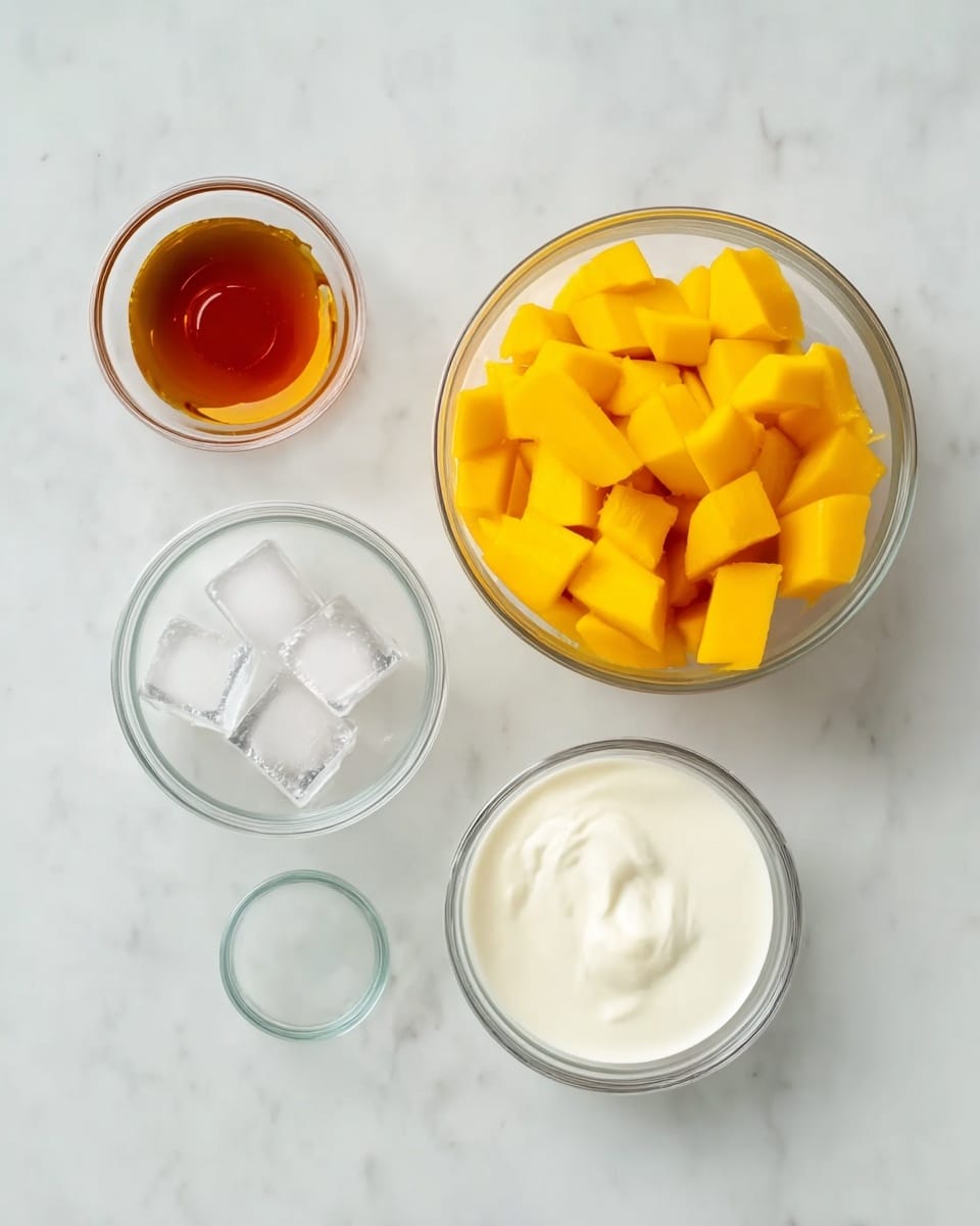 The image shows five small glass bowls arranged on a white marbled surface. The largest bowl is filled with bright yellow mango pieces, cut into small cubes with a juicy texture, placed at the bottom right. To its top right is a smaller bowl with smooth, white coconut milk. To the left of the mango bowl is a bowl filled with thick, creamy white yogurt. Above that, a smaller bowl holds three clear ice cubes with sharp edges. To the far left, the smallest bowl contains golden amber vanilla extract with a shiny surface. photo taken with an iphone --ar 4:5 --v 7